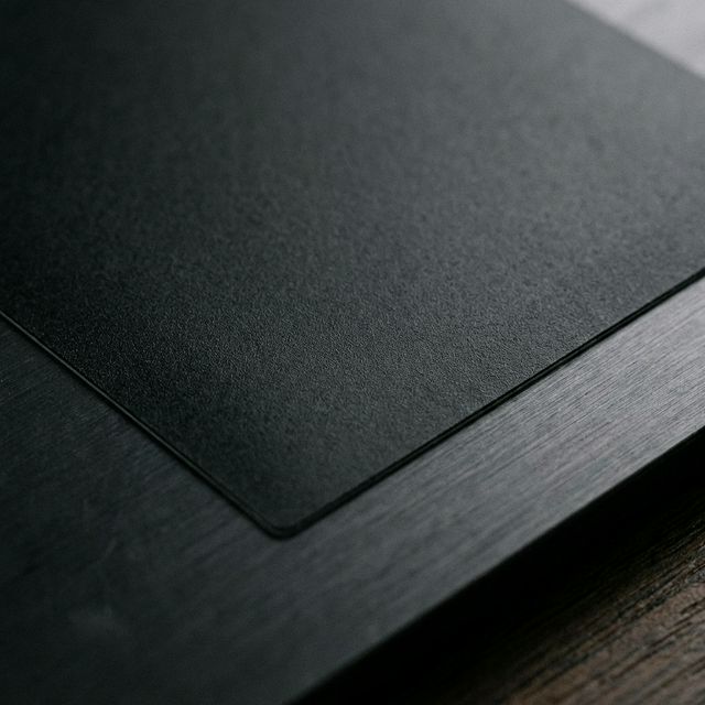 Un acercamiento extremo a un sticker mate, revelando una textura suave sin ningún brillo rebotando.